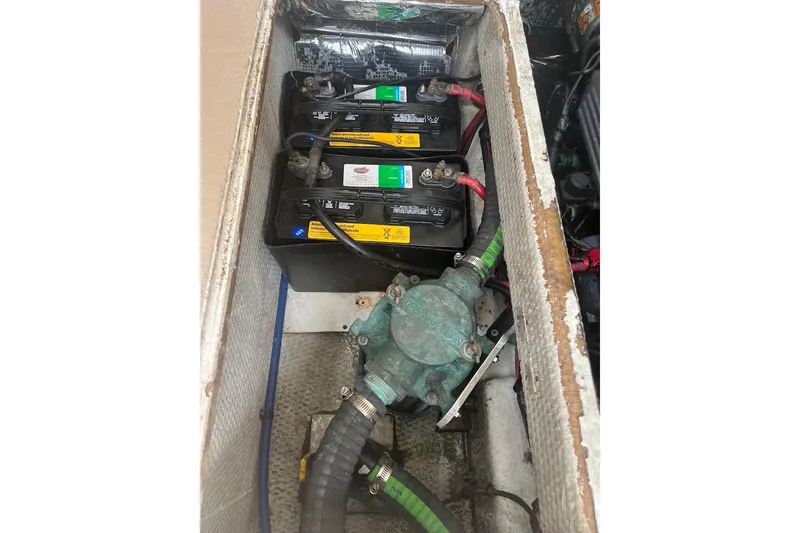 Slide: The Image of Battery compartment of a 1998 General Marine Custom Downeast boat, showing multiple batteries and wiring. - 14