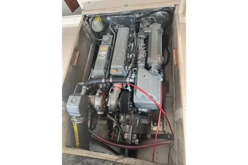 Slide: The Image of Engine compartment of a 1998 General Marine Custom Downeast boat, showcasing mechanical components. - 16