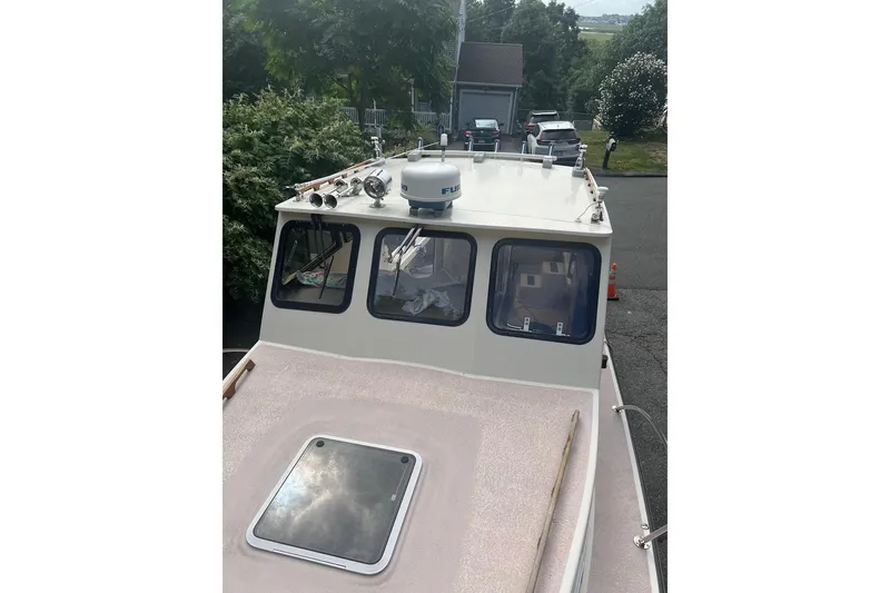 Slide: The Image of 1998 General Marine Custom Downeast boat with radar and windows, parked outdoors. - 5