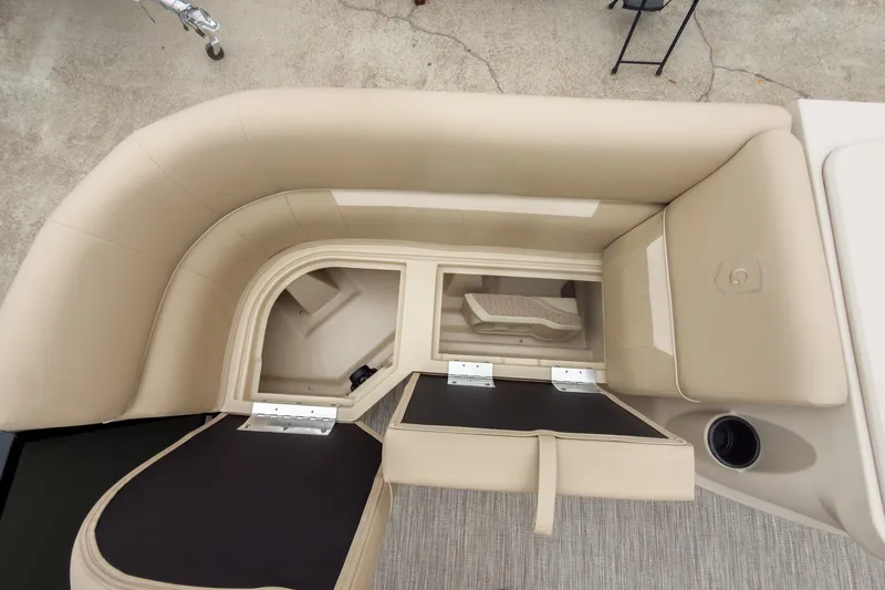 Slide: The Image of 2026 Godfrey Sweetwater Xperience 20' pontoon with open storage compartments and beige seating. - 17