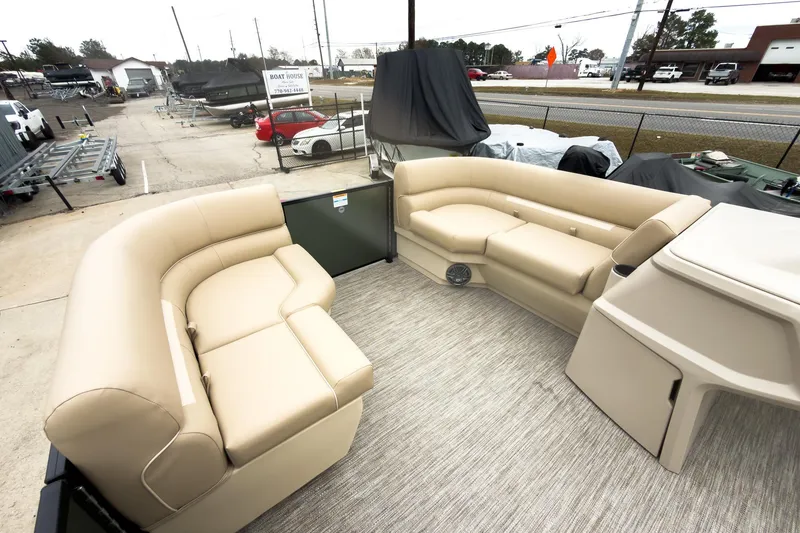Slide: The Image of 2026 Godfrey Sweetwater Xperience 20' pontoon with beige lounge seating, docked outdoors. - 24