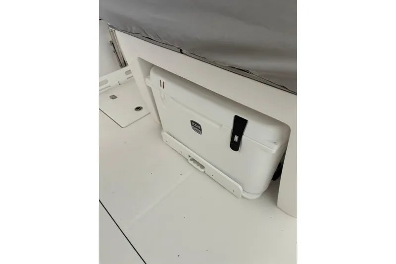Slide: The Image of White cooler on 2020 Edgewater 262CC boat deck, secured under seating. - 14