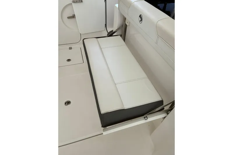 Slide: The Image of 2020 Edgewater 262CC boat interior with white cushioned seating. - 15
