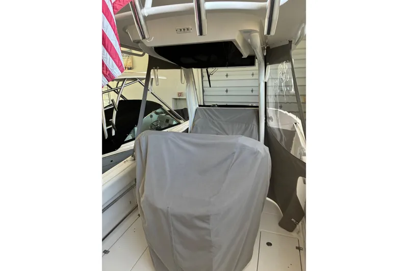 Slide: The Image of 2020 Edgewater 262CC boat interior with protective covers and American flag. - 3