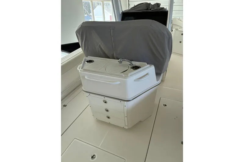 Slide: The Image of 2020 Edgewater 262CC boat interior with covered console and storage drawers. - 9