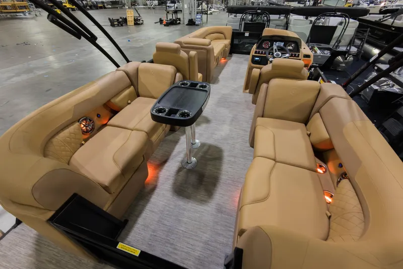 Slide: The Image of 2026 Godfrey Sweetwater 22' Tritoon interior with luxurious tan seating and modern amenities. - 19