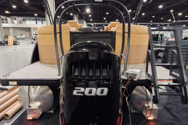 Slide: The Image of 2026 Godfrey Sweetwater 22' Tritoon with 200 HP engine, showcased indoors. - 20