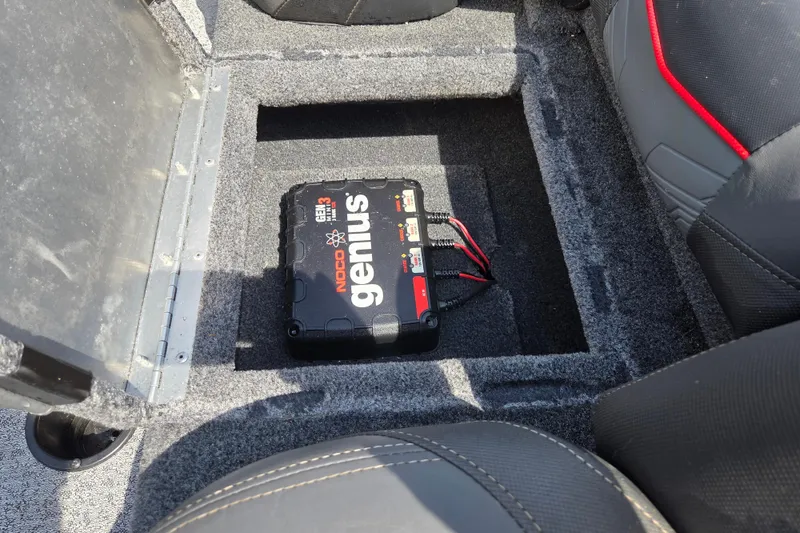 Slide: The Image of NOCO Genius battery charger in 2021 Tracker Pro Team 175 TXW Tournament Edition boat compartment. - 11