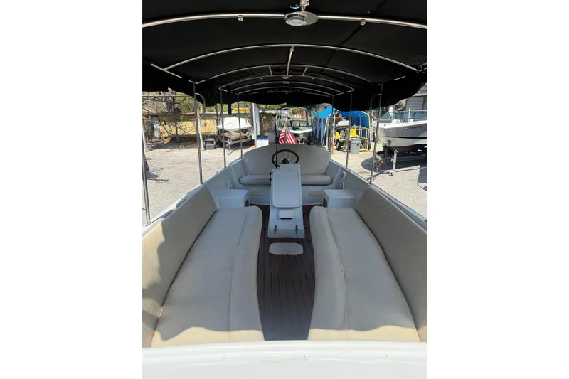 Slide: The Image of 2004 Duffy 18 electric boat interior with canopy and seating, showcasing spacious design. - 4