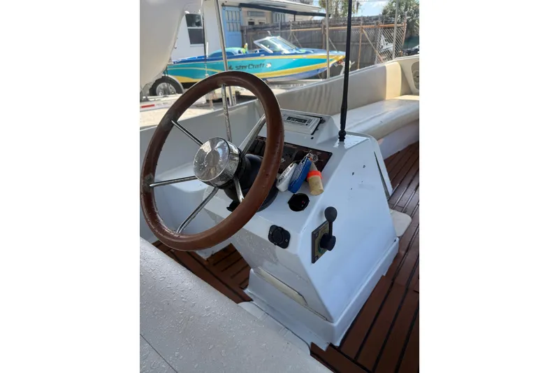 Slide: The Image of Steering console of a 2004 Duffy 18 electric boat with wooden accents. - 5