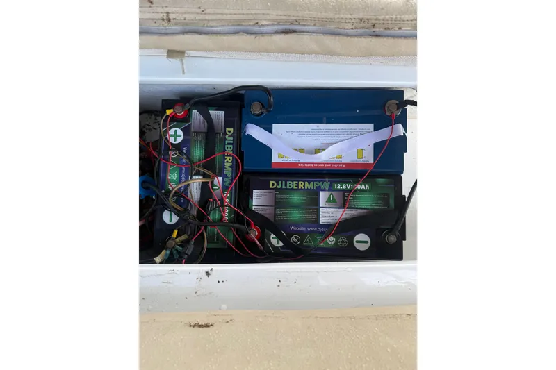 Slide: The Image of Battery compartment of a 2004 Duffy 18 electric boat, featuring DJLBERMPW batteries. - 6