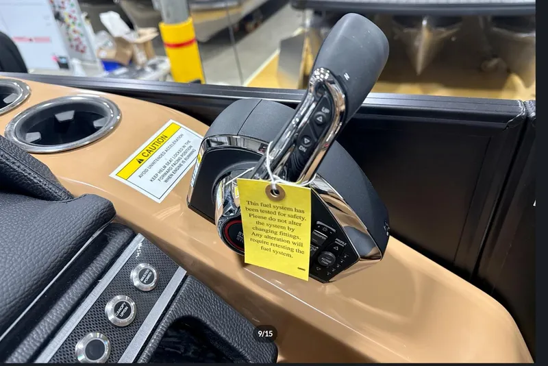 Slide: The Image of Control panel of 2026 Godfrey Monaco 23' Tritoon with caution label and cup holders. - 12