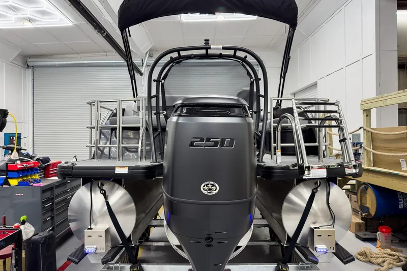 Slide: The Image of 2026 Godfrey Monaco 23' Tritoon with 250 HP engine in a workshop setting. - 10