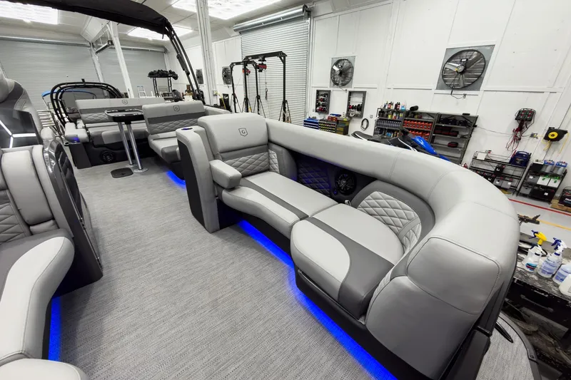 Slide: The Image of Luxurious interior of 2026 Godfrey Monaco 23' Tritoon with plush seating and ambient lighting. - 14