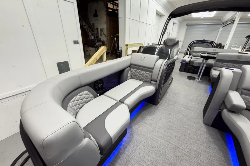Slide: The Image of Luxurious interior of 2026 Godfrey Monaco 23' Tritoon with stylish seating and ambient lighting. - 15