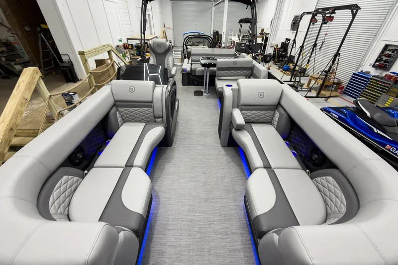 Slide: The Image of Luxurious interior of 2026 Godfrey Monaco 23' Tritoon with plush seating and ambient lighting. - 16