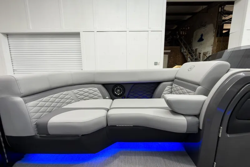 Slide: The Image of Luxurious interior of 2026 Godfrey Monaco 23' Tritoon with elegant gray seating and ambient lighting. - 17