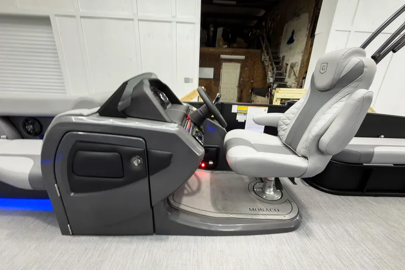 Slide: The Image of 2026 Godfrey Monaco 23' Tritoon interior with sleek helm and luxurious seating. - 21