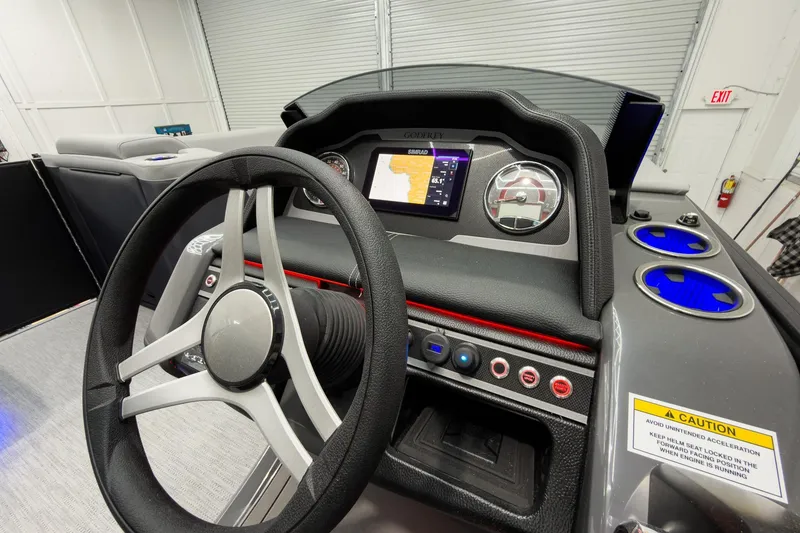 Slide: The Image of Steering console of 2026 Godfrey Monaco 23' Tritoon with modern controls and navigation display. - 24