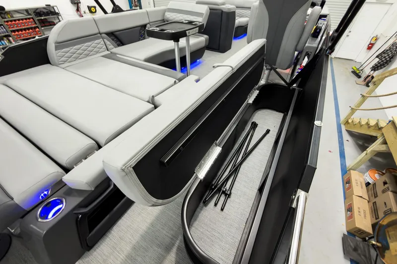 Slide: The Image of 2026 Godfrey Monaco 23' Tritoon interior with flip lounge and storage compartment. - 42