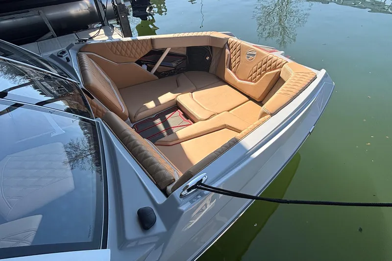 Slide: The Image of 2026 Tigé 24RZX boat with luxurious tan seating, docked on calm water. - 10