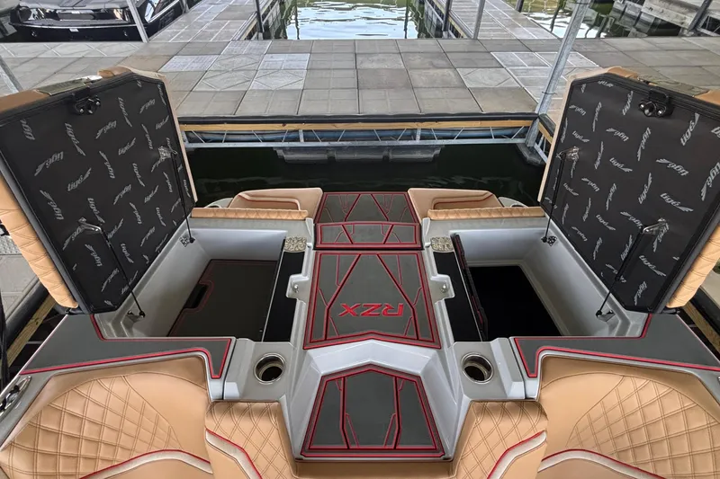 Slide: The Image of 2026 Tigé 24RZX boat interior with open storage compartments and luxurious seating. - 14