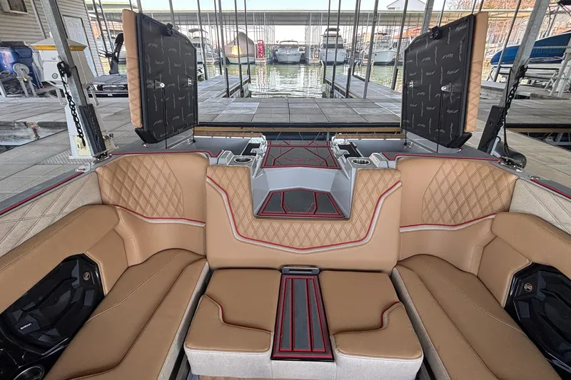 Slide: The Image of Luxurious interior of 2026 Tigé 24RZX boat with tan seating and red accents. - 15