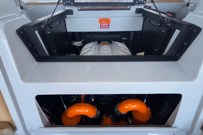 Slide: The Image of Engine compartment of 2026 Tigé 24RZX boat, featuring vibrant orange components. - 16