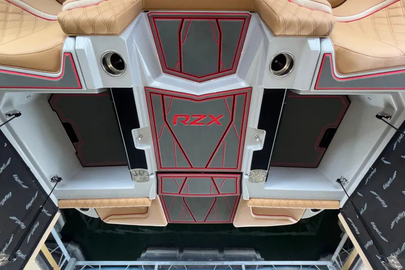 Slide: The Image of 2026 Tigé 24RZX boat interior with tan seats and red-accented flooring. - 19