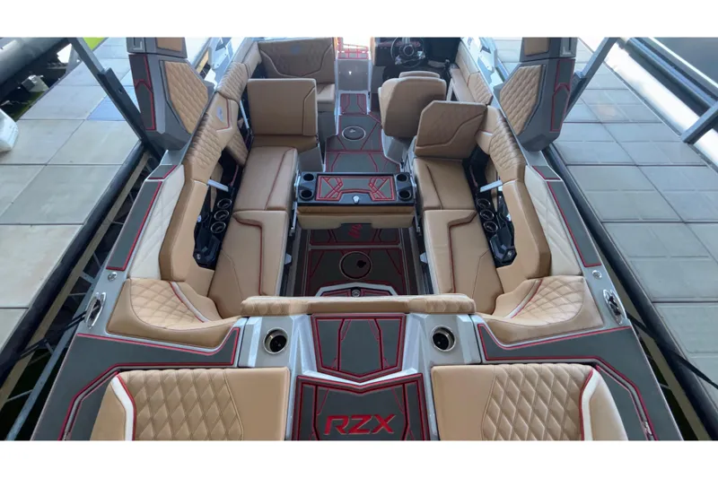 Slide: The Image of Luxurious interior of 2026 Tigé 24RZX boat with beige seating and red accents. - 20