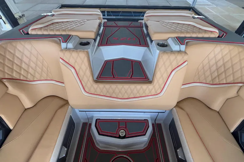 Slide: The Image of Luxurious interior of 2026 Tigé 24RZX boat with tan and red accents. - 22