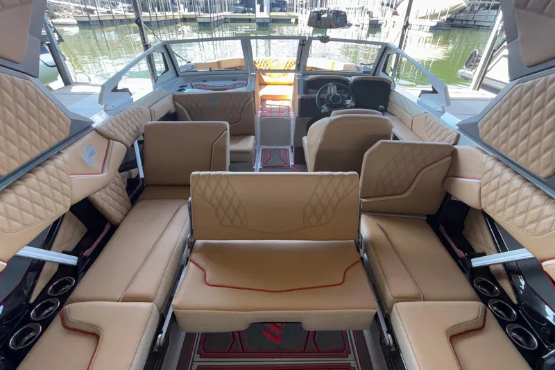 Slide: The Image of Luxurious interior of 2026 Tigé 24RZX boat with tan quilted seating. - 24