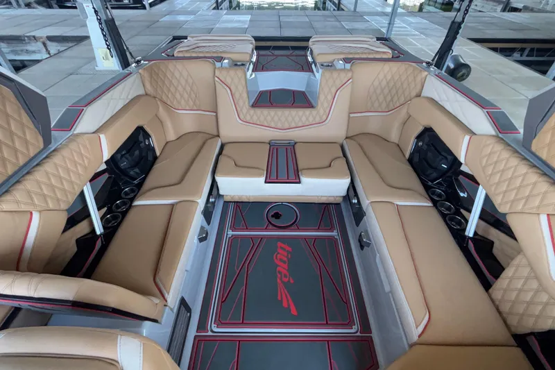 Slide: The Image of Luxurious interior of 2026 Tigé 24RZX boat with tan leather seating and red accents. - 28