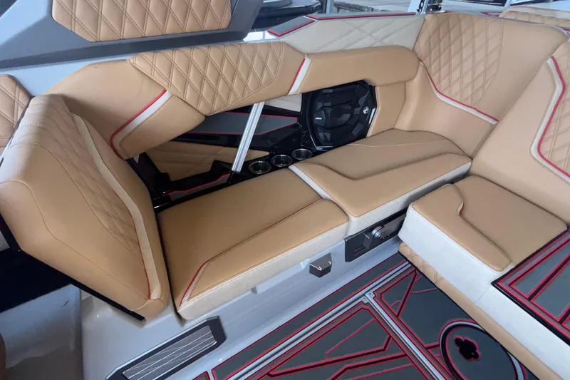 Slide: The Image of Luxurious interior seating of 2026 Tigé 24RZX boat with tan upholstery and red accents. - 29