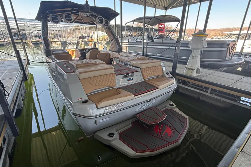 Slide: The Image of 2026 Tigé 24RZX boat docked, featuring luxurious seating and modern design. - 3