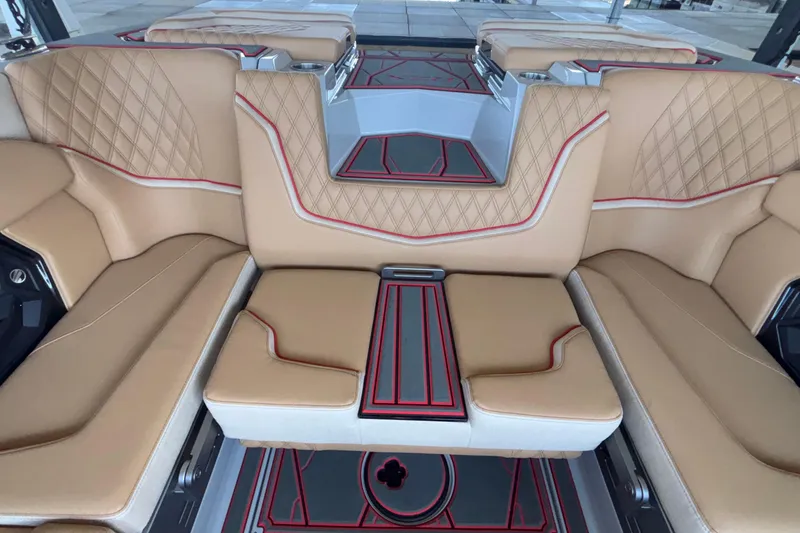 Slide: The Image of Luxurious interior of 2026 Tigé 24RZX boat with tan leather seating and red accents. - 30