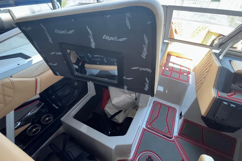 Slide: The Image of Interior view of a 2026 Tigé 24RZX boat, showcasing seating and storage compartments. - 38
