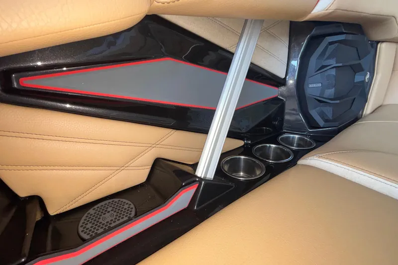 Slide: The Image of 2026 Tigé 24RZX interior with tan leather seats, cup holders, and speaker system. - 43