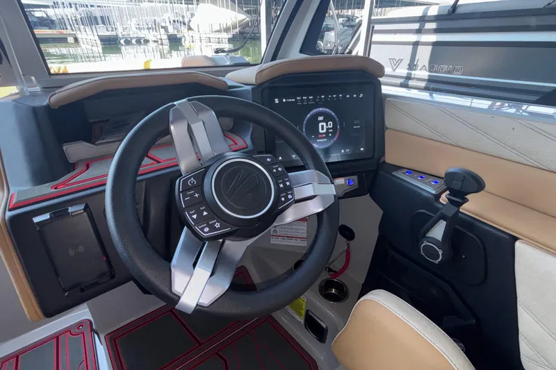 Slide: The Image of 2026 Tigé 24RZX boat dashboard with modern steering wheel and digital display. - 46