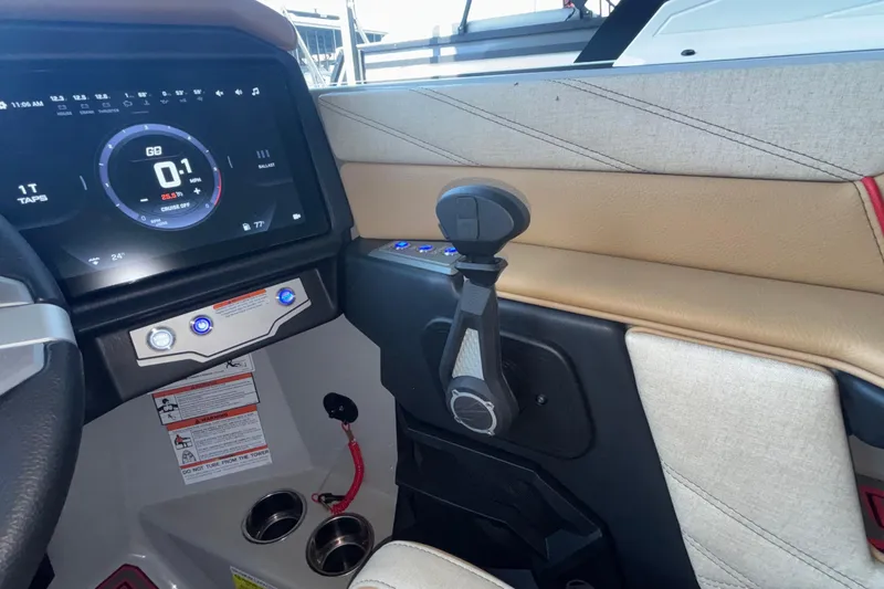 Slide: The Image of 2026 Tigé 24RZX boat dashboard with digital display and control lever. - 49