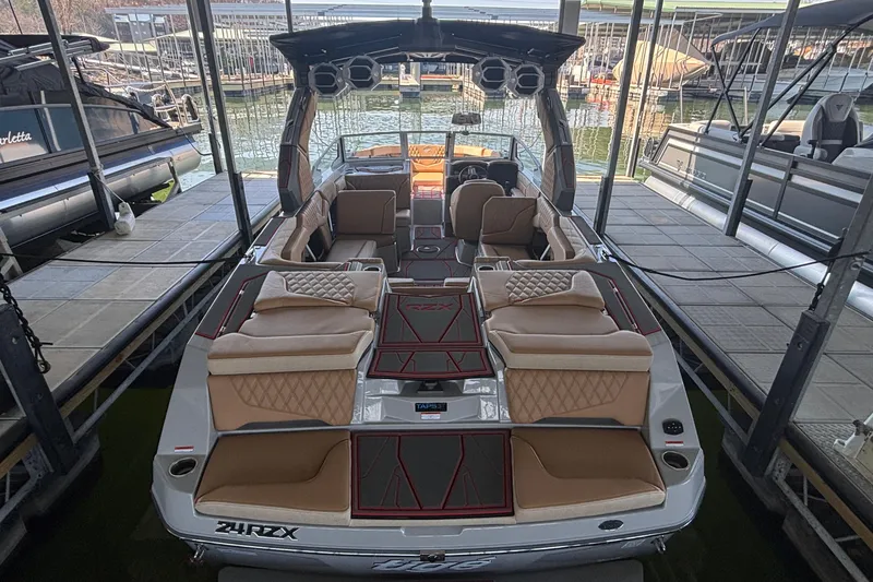 Slide: The Image of 2026 Tigé 24RZX boat with luxurious seating, docked at a marina. - 5