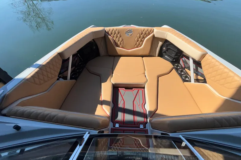 Slide: The Image of Luxurious interior of 2026 Tigé 24RZX boat with tan seating and cup holders. - 54