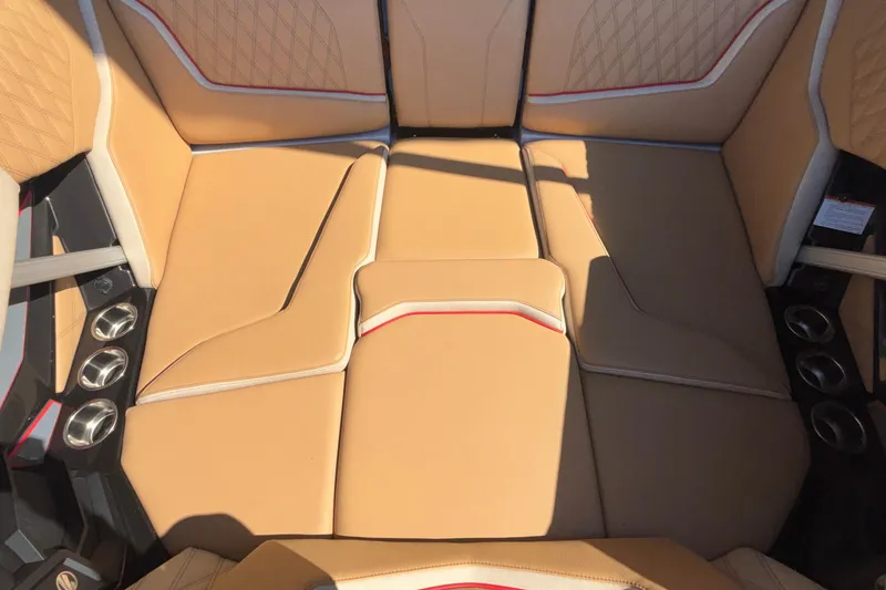 Slide: The Image of Luxurious tan seating in 2026 Tigé 24RZX boat interior with cup holders. - 58