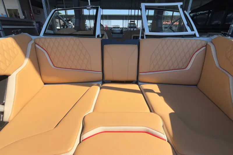 Slide: The Image of 2026 Tigé 24RZX boat interior with tan leather seating and diamond stitching. - 59
