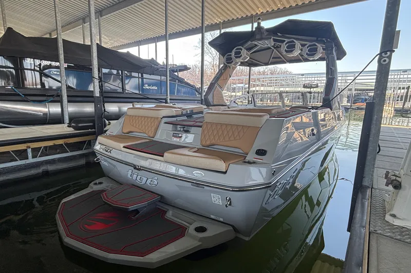 Slide: The Image of 2026 Tigé 24RZX boat docked, featuring sleek design and luxurious seating. - 6