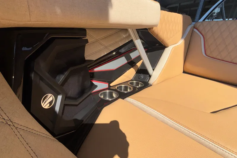 Slide: The Image of Luxurious interior of 2026 Tigé 24RZX boat with tan upholstery and cup holders. - 60