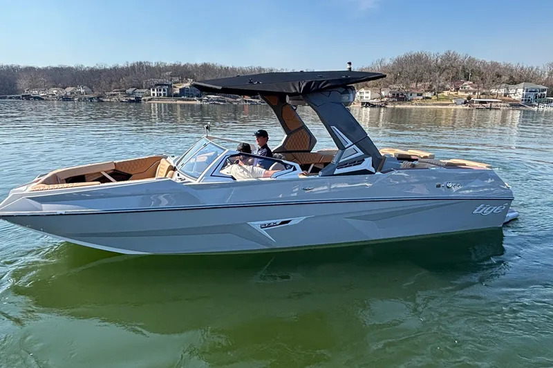 Slide: The Image of 2026 Tigé 24RZX boat on a calm lake, featuring sleek design and modern amenities. - 64