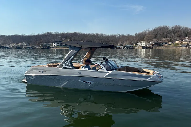 Slide: The Image of 2026 Tigé 24RZX boat on a calm lake, featuring sleek design and modern amenities. - 65