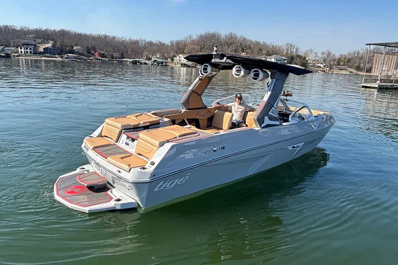 Slide: The Image of 2026 Tigé 24RZX boat on a calm lake, featuring sleek design and luxurious seating. - 67