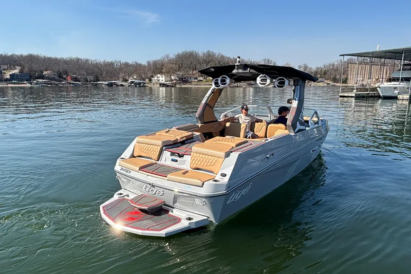 Slide: The Image of 2026 Tigé 24RZX boat on a calm lake, featuring luxurious seating and sleek design. - 68